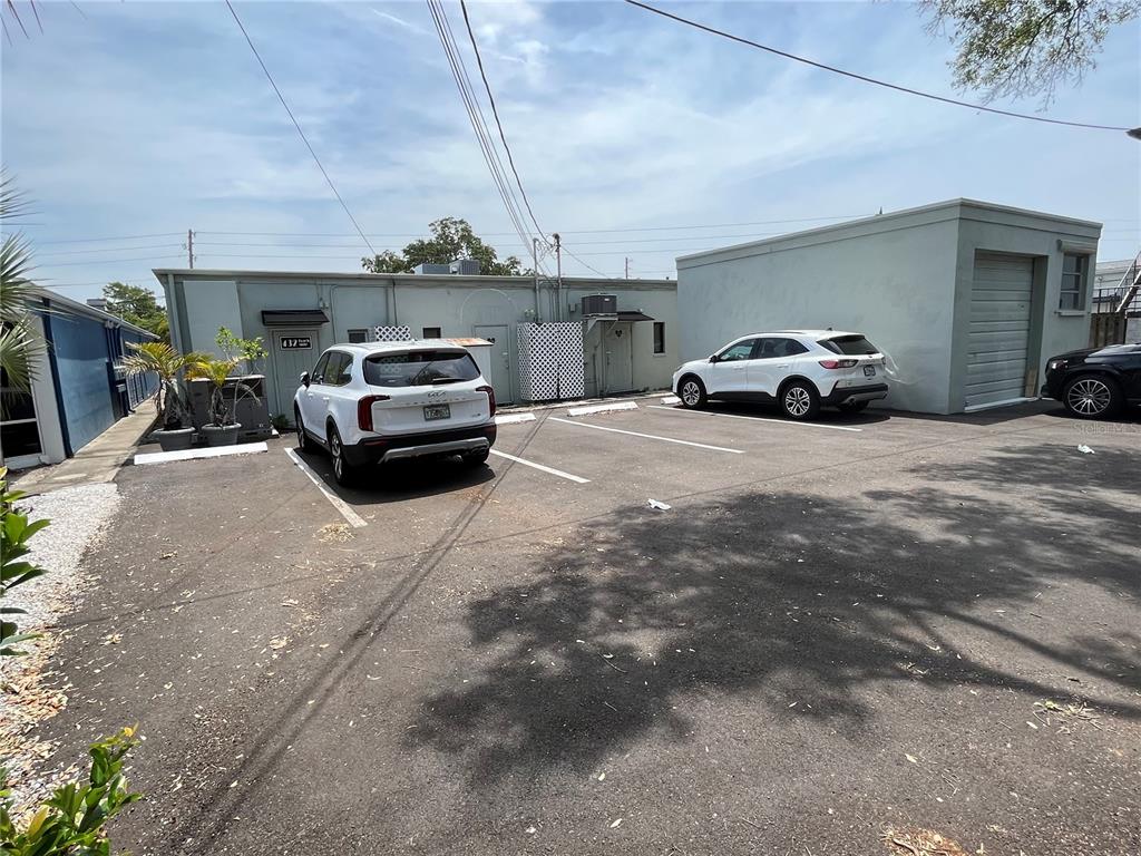 A paved parking lot sits in front of a single-story building with two parked SUVs — 420 INDIAN ROCKS ROAD N, BELLEAIR BLUFFS, FL