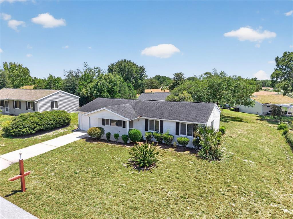 An aerial view of a single-story house with a gray roof and white siding — 8720 SW 108TH LANE, OCALA, FL