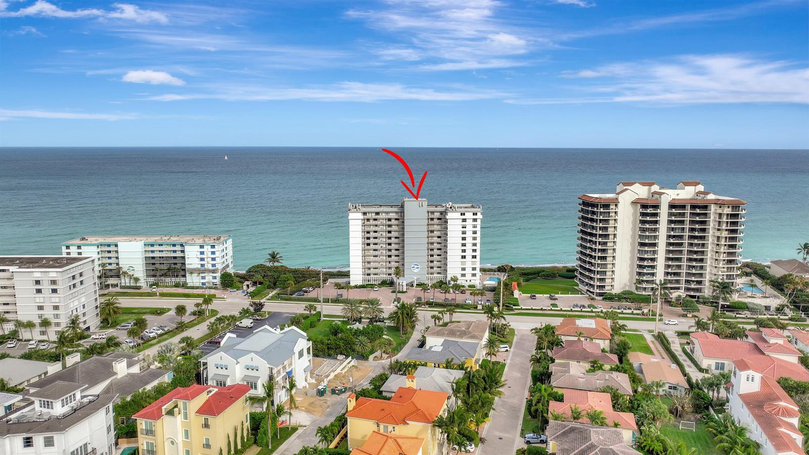 An aerial view shows a high-rise beachfront condominium building with a red arrow pointing down — 840 Ocean Drive # 806, Juno Beach FL 33408, JUNO BEACH, FL