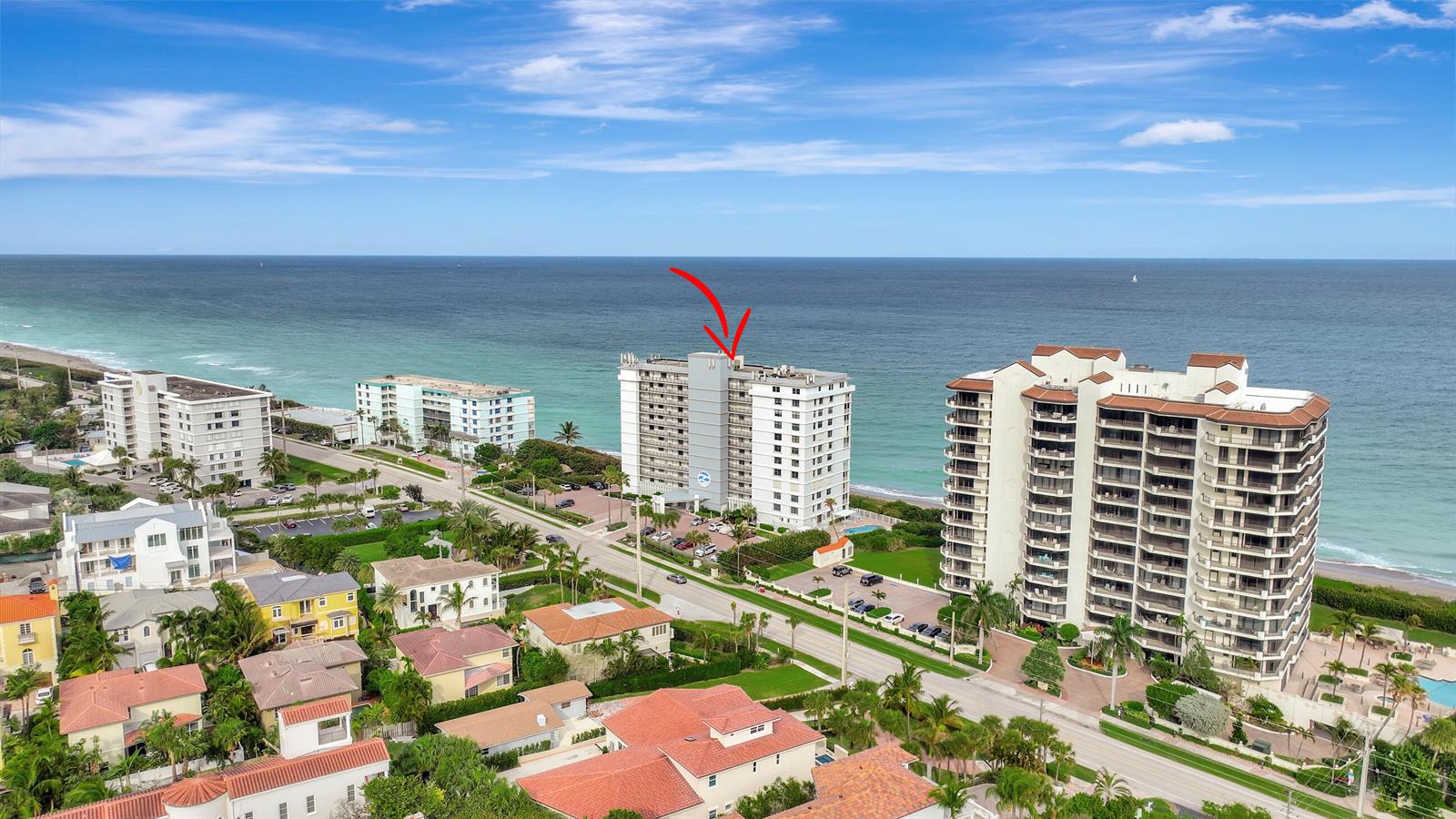 An aerial view shows a multi-story beachfront condominium building marked with a red arrow — 840 Ocean Drive # 806, Juno Beach FL 33408, JUNO BEACH, FL