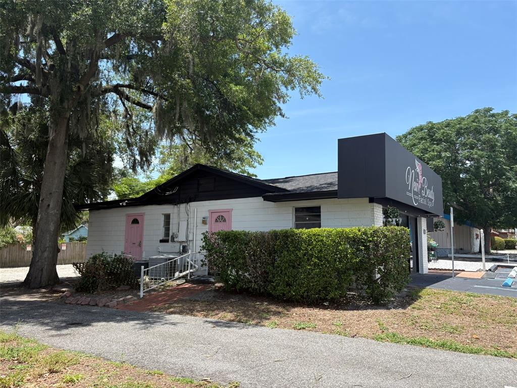 A single-story commercial building with white block walls, pink doors, and a black awning — 264 E ALTAMONTE DRIVE, ALTAMONTE SPRINGS, FL