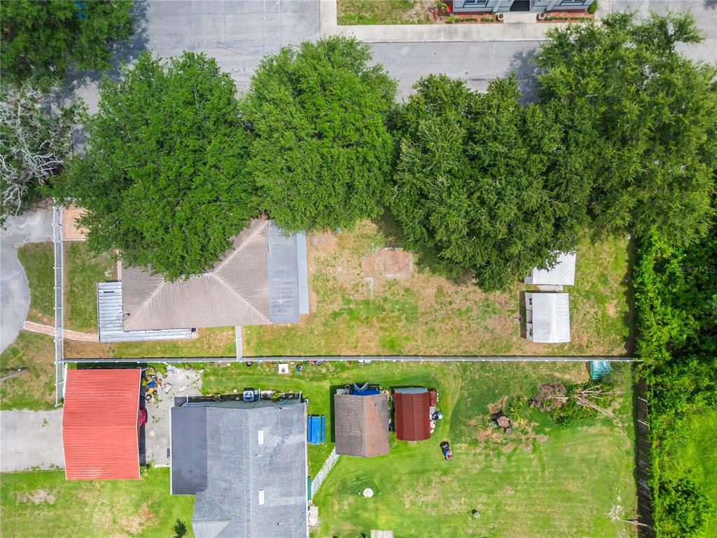 An aerial view shows two adjacent residential properties with houses, outbuildings, and mature trees — 1855 PROCTOR AVENUE, ORLANDO, FL
