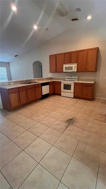 A kitchen with wood cabinets, white countertops, and light-colored tile flooring — 451 PEACE COURT, KISSIMMEE, FL