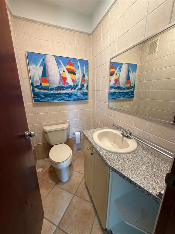 A balcony with tiled flooring, a green metal railing, and two sets of French doors — 968 COSTA DORADA UNIT A-102, RIO GRANDE, PR