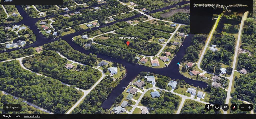 This aerial map view shows a vacant, wooded residential lot surrounded by canals and houses — 1089 MARCH DRIVE, PORT CHARLOTTE, FL