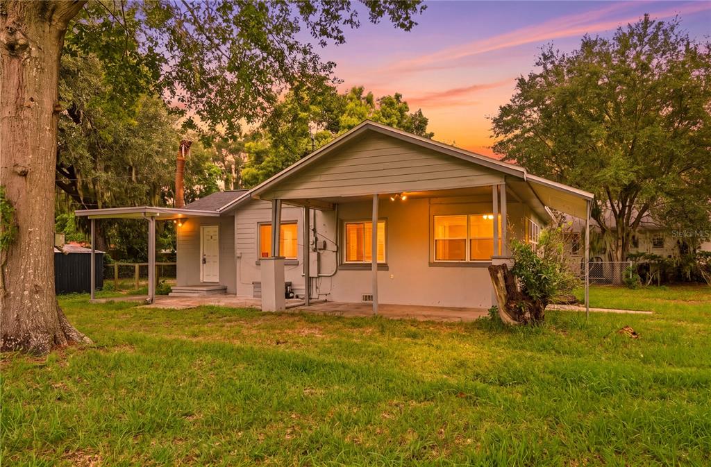 A single-story house with a covered patio and light gray siding sits on a grassy lot — 730 WESTOVER PARKWAY, BARTOW, FL