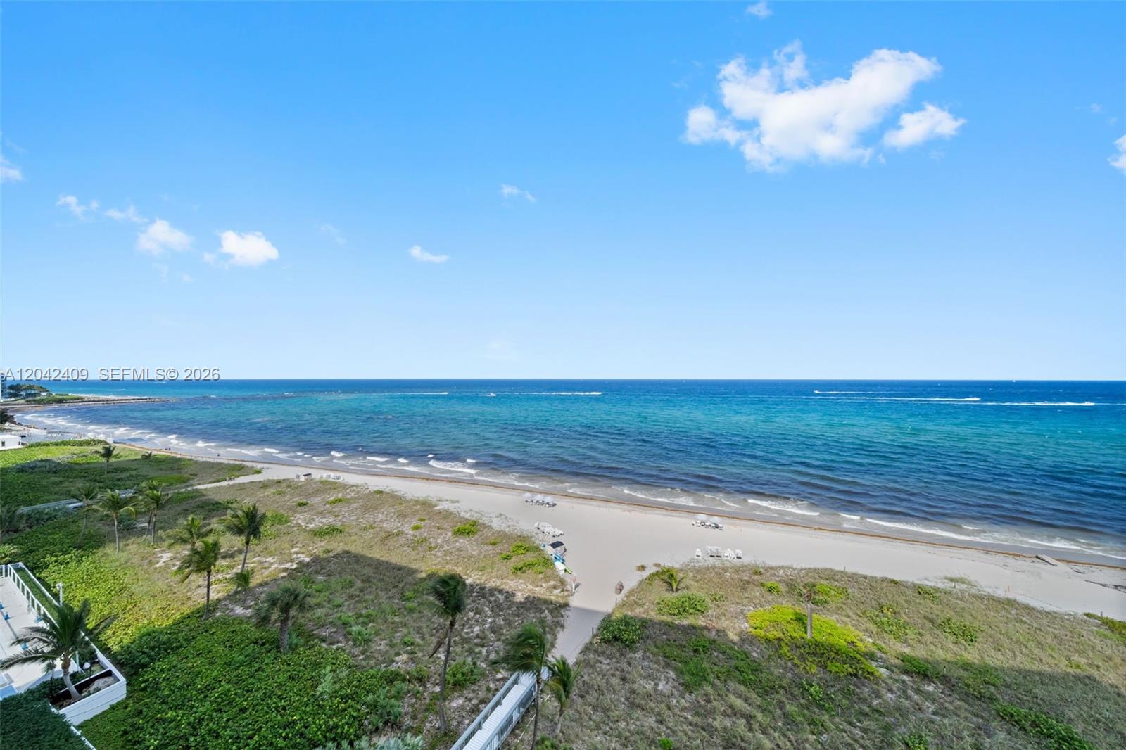 An elevated view of a sandy beach and the ocean under a blue sky — 1500 S Ocean Blvd # 804, Boca Raton FL 33432, BOCA RATON, FL