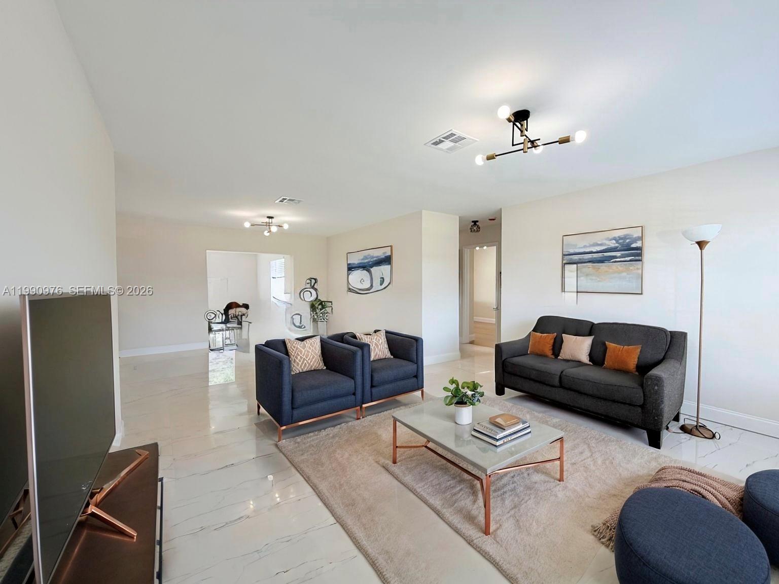 A living room features a dark sofa, two armchairs, a coffee table, and tile flooring — 4731 NW 11th St, Lauderhill FL 33313, LAUDERHILL, FL