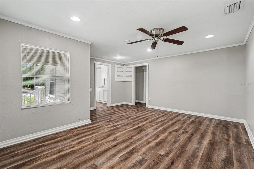 A living room with gray walls, wood-look flooring, a ceiling fan, and recessed lighting — 828 E 145TH AVENUE, TAMPA, FL