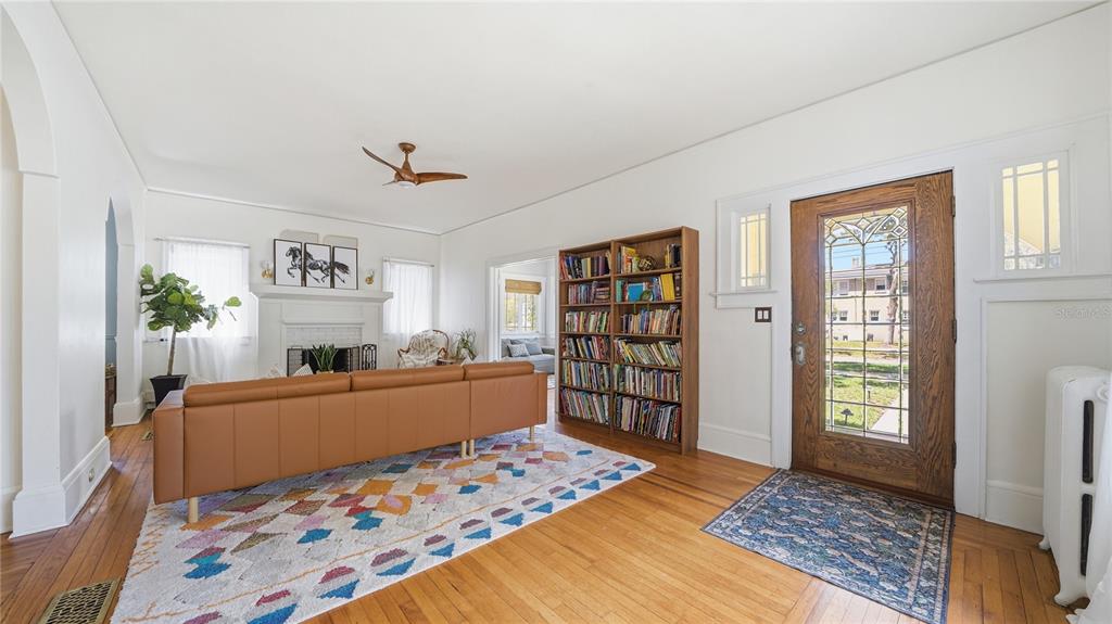 A living room features hardwood floors, a brown sofa, a bookshelf, and a front door — 1544 TALBOT AVENUE, JACKSONVILLE, FL