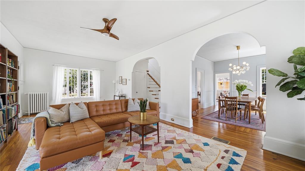 A living room with a brown leather sectional, patterned rug, and arched doorways to dining — 1544 TALBOT AVENUE, JACKSONVILLE, FL