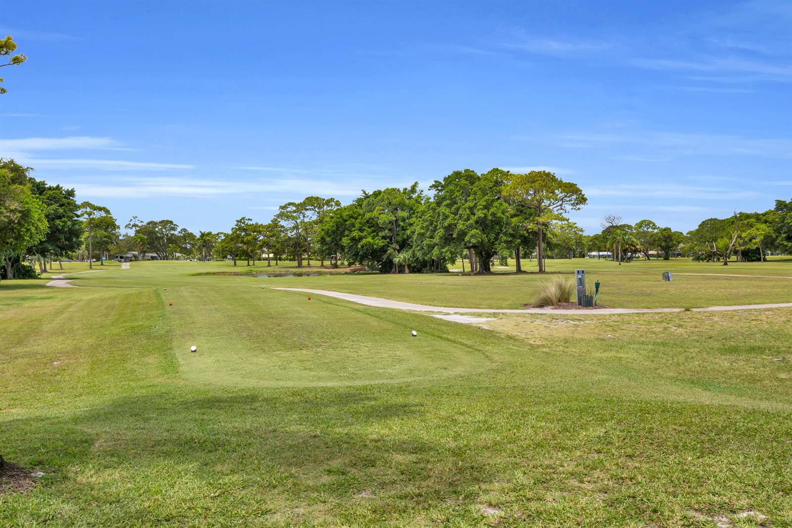 A view of a golf course fairway with trees and a paved cart path — 1225 NW 21st Street # 1502, Stuart FL 34994, STUART, FL