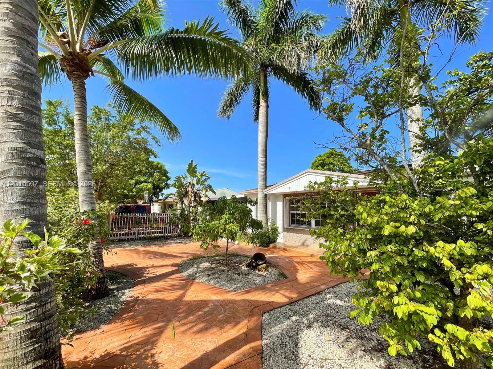 A front yard features a stamped concrete walkway, palm trees, and a small gravel garden — 22430 SW 113th Ct, Miami FL 33170, MIAMI, FL