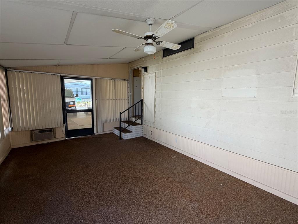 A kitchen with light wood cabinets, a white refrigerator, and a breakfast bar — 1007 CASSANDRA LANE, LAKELAND, FL