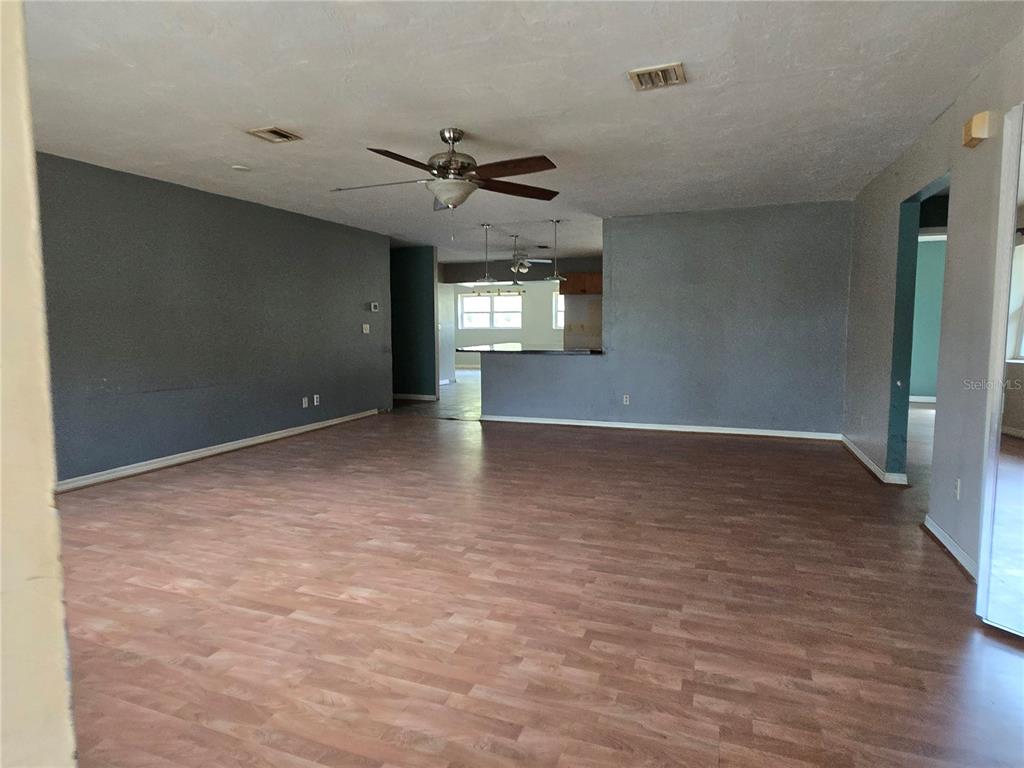 An empty bedroom with dark gray walls, light wood-look flooring, and a single window — 4711 S HAWKDALE POINT, LECANTO, FL