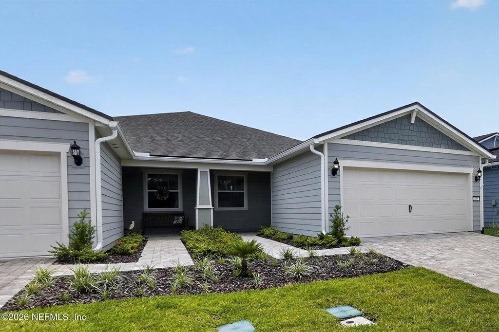 A light gray house with a two-car garage and a paved walkway to the entrance — 436 JUBILEE CIRCLE, YULEE, FL