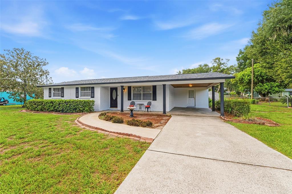 A single-story white brick house features a front porch, carport, and a concrete driveway — 3825 SWINDELL ROAD, PLANT CITY, FL