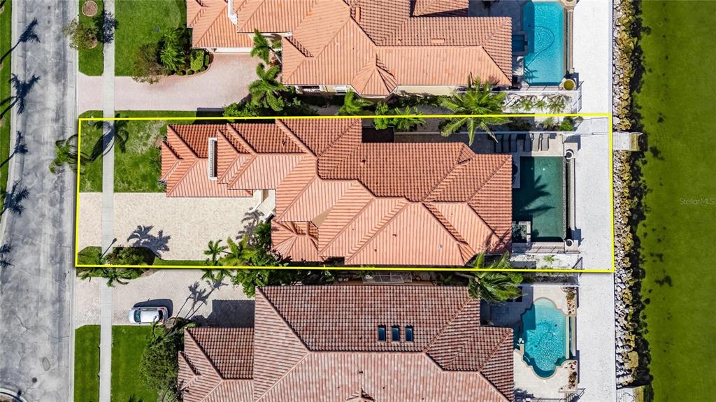 An aerial view shows a residential house with a tiled roof, pool, and waterfront backyard — 6418 BRIGHT BAY COURT, APOLLO BEACH, FL