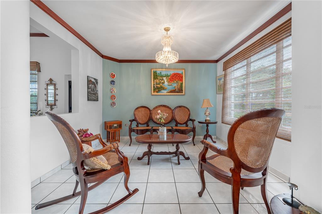 A living room features a light blue accent wall, tiled floors, and vintage wooden furniture — SR 100 k2h7 int Guanajibo PLAN BONITO ST, CABO ROJO, PR