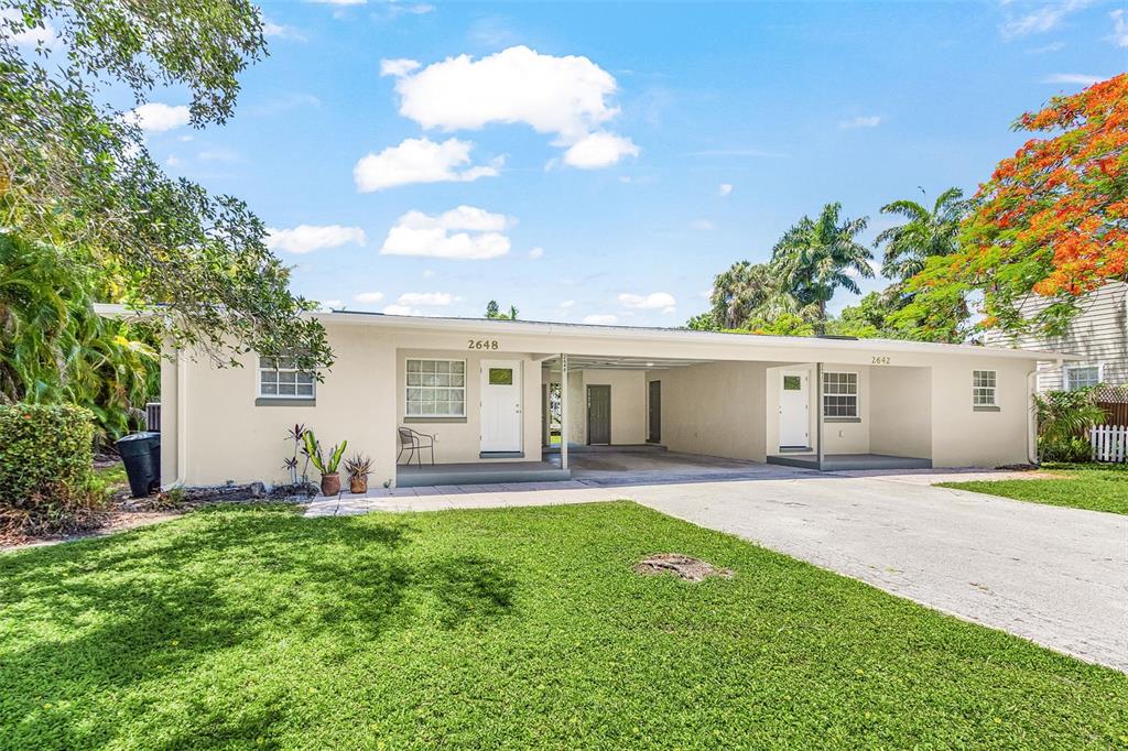 A single-story duplex with a shared carport and two separate entrances under a flat roof — 2648 MICHIGAN AVENUE, FORT MYERS, FL
