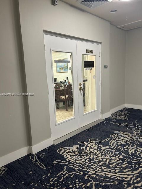 A set of double glass doors labeled CU-8 opens into an office with patterned carpeting — 5601 Collins Ave, Miami Beach FL 33140, MIAMI BEACH, FL