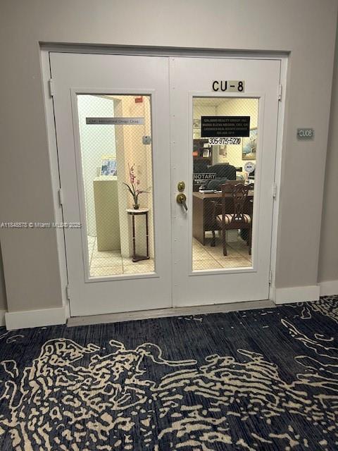 A set of double glass doors labeled CU-8 opens into an office space with carpeted flooring — 5601 Collins Ave, Miami Beach FL 33140, MIAMI BEACH, FL