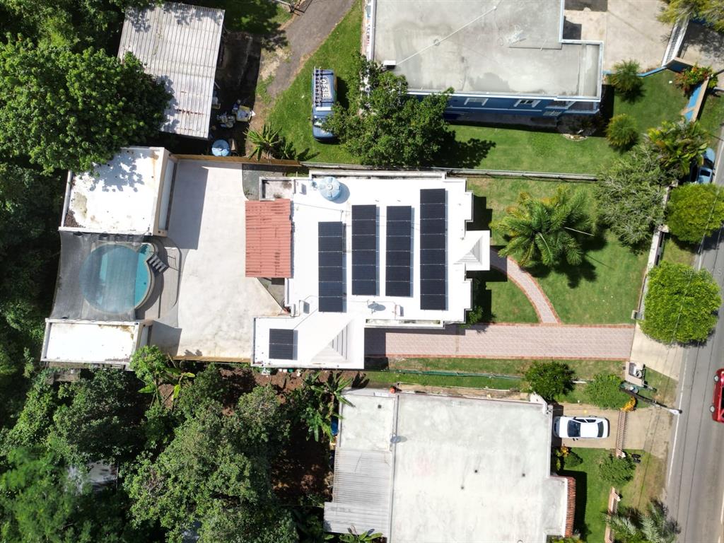 An aerial view shows a house with a swimming pool and solar panels on the roof — 478 SAN ANTONIO, QUEBRADILLAS, PR