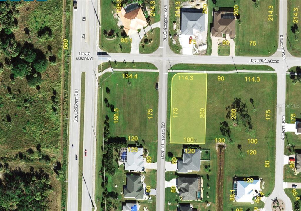 This is an aerial map showing a vacant lot highlighted in yellow near a road intersection — 7400 S SEAGRAPE ROAD, PUNTA GORDA, FL
