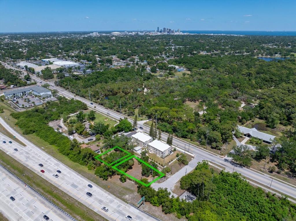An aerial view shows two adjacent vacant lots outlined in green next to a highway — 30TH AVENUE S, ST PETERSBURG, FL