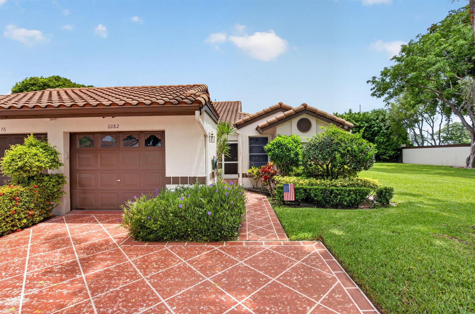 A single-story house with a brown garage, tiled roof, and a red patterned driveway — 6082 Waldwick Circle, Delray Beach FL 33484, DELRAY BEACH, FL