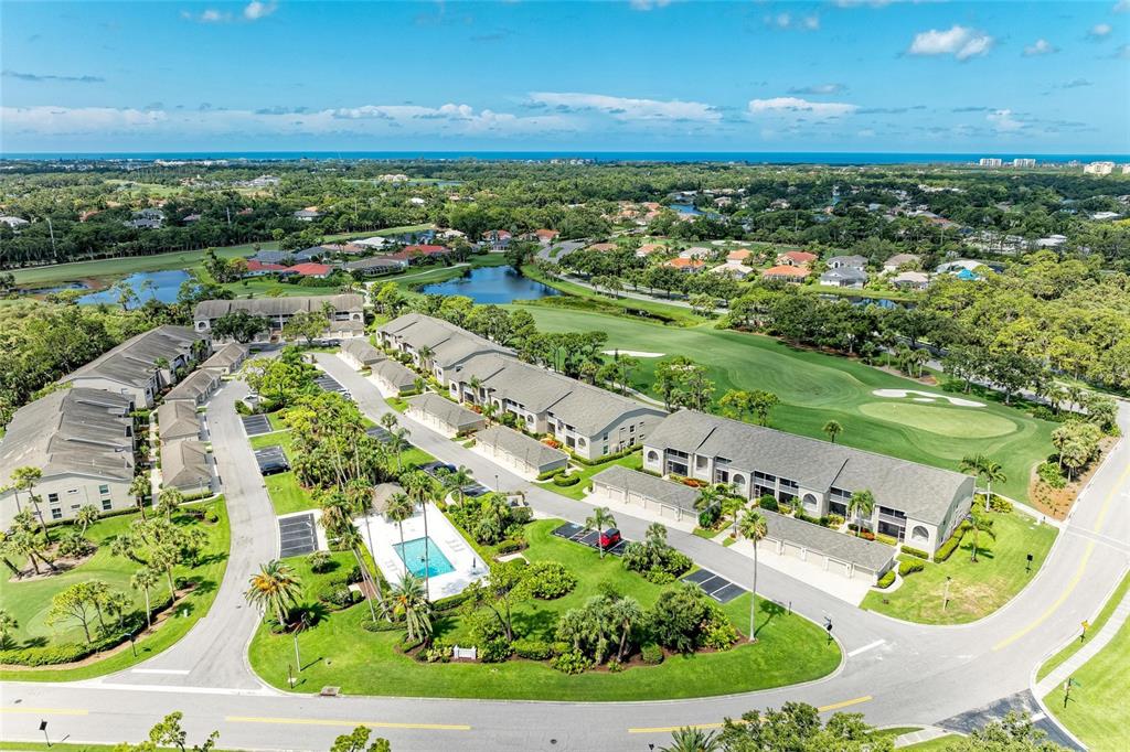 An aerial view shows multi-unit residential buildings, a swimming pool, and a golf course — 9560 HIGH GATE DRIVE UNIT 1626, SARASOTA, FL
