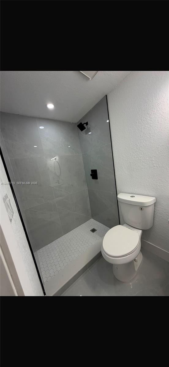 A bathroom features a glass-enclosed walk-in shower with grey tile and a white toilet — 14321 Madison St # 1, Miami FL 33176, MIAMI, FL