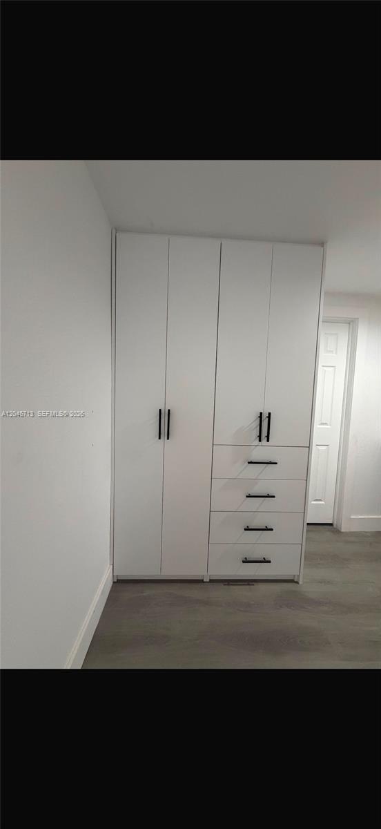 A white wardrobe with two doors and four drawers stands against a wall — 14321 Madison St # 1, Miami FL 33176, MIAMI, FL