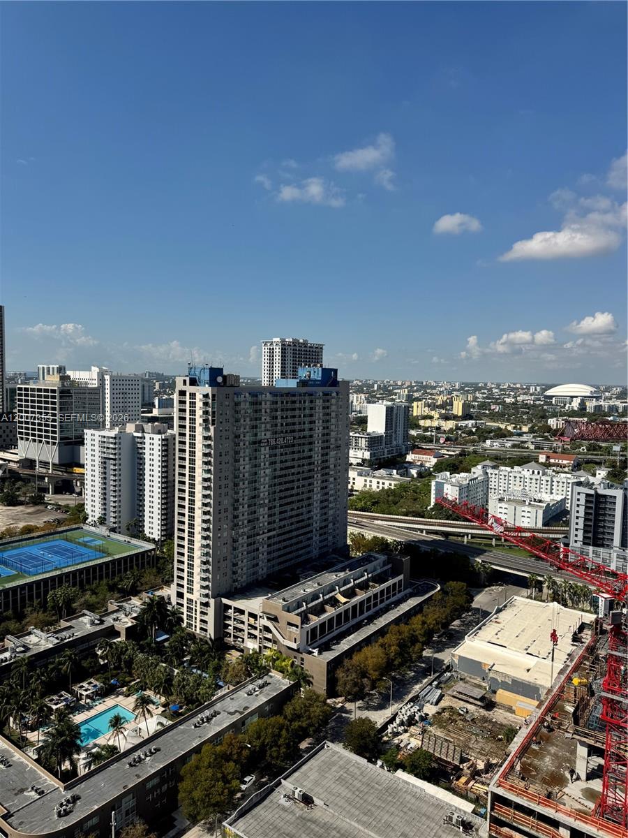 An elevated view shows a city skyline with high-rise buildings, a tennis court, and construction — 20 NE 11th St # 3012A, Miami FL 33132, MIAMI, FL
