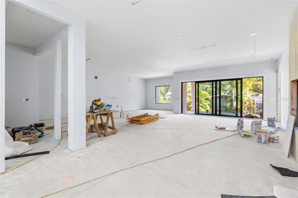 A modern black front door with geometric patterns is flanked by glass panels — 4709 W ESTRELLA STREET, TAMPA, FL