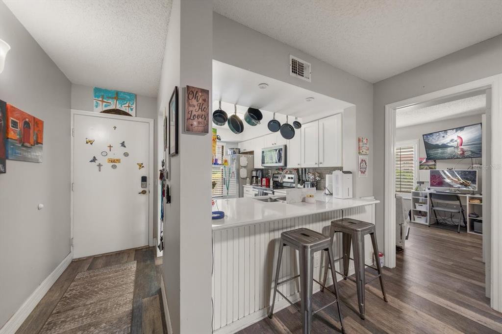 An entryway leads to a kitchen with a breakfast bar and an adjacent home office — 6219 PALMA DEL MAR BOULEVARD S UNIT 102, ST PETERSBURG, FL