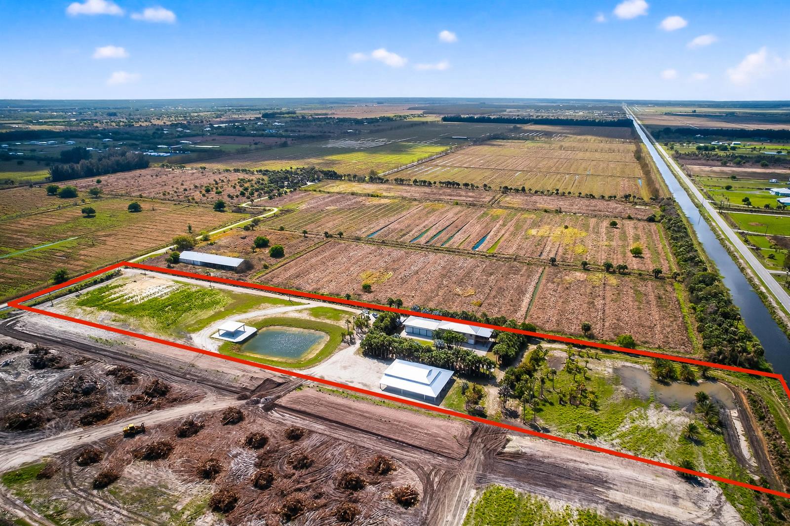 An aerial view shows a rectangular property with buildings, ponds, and palm trees — 200 S Graves Road, Fort Pierce FL 34945, FORT PIERCE, FL