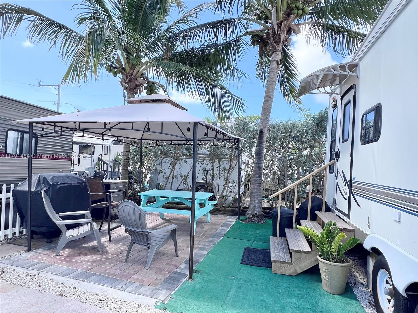 An outdoor patio area features a gazebo, a picnic table, chairs, and a parked RV — 325 Calusa St #5, Key Largo FL 33037, KEY LARGO, FL