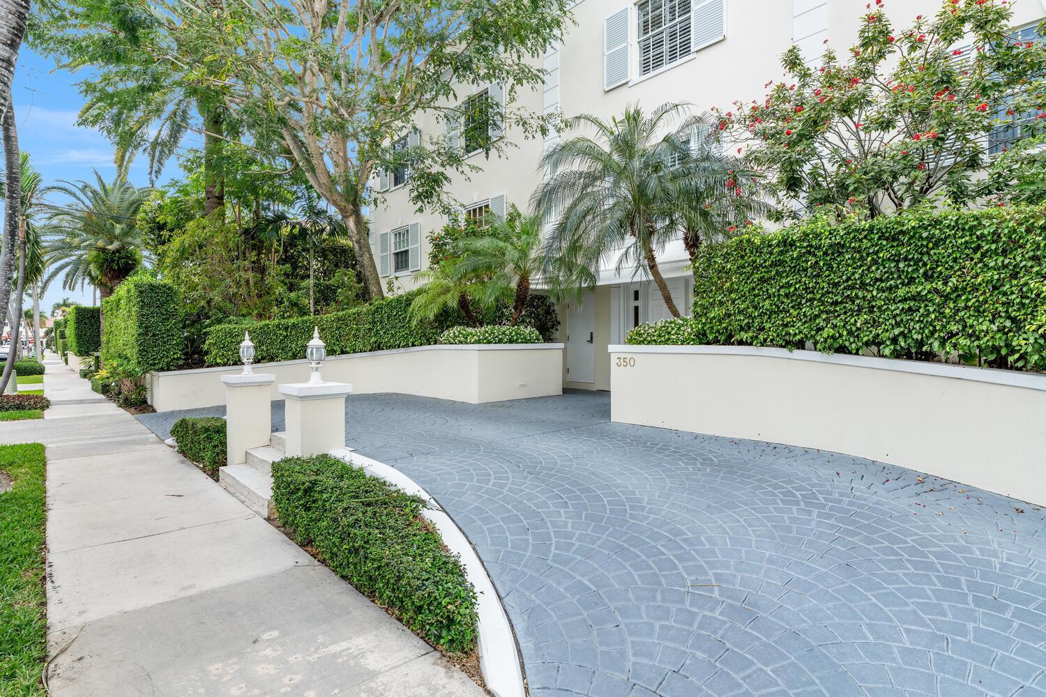 A paved driveway leads to the entrance of a multi-story building with lush landscaping — 350 Cocoanut Row # 3a, Palm Beach FL 33480, PALM BEACH, FL