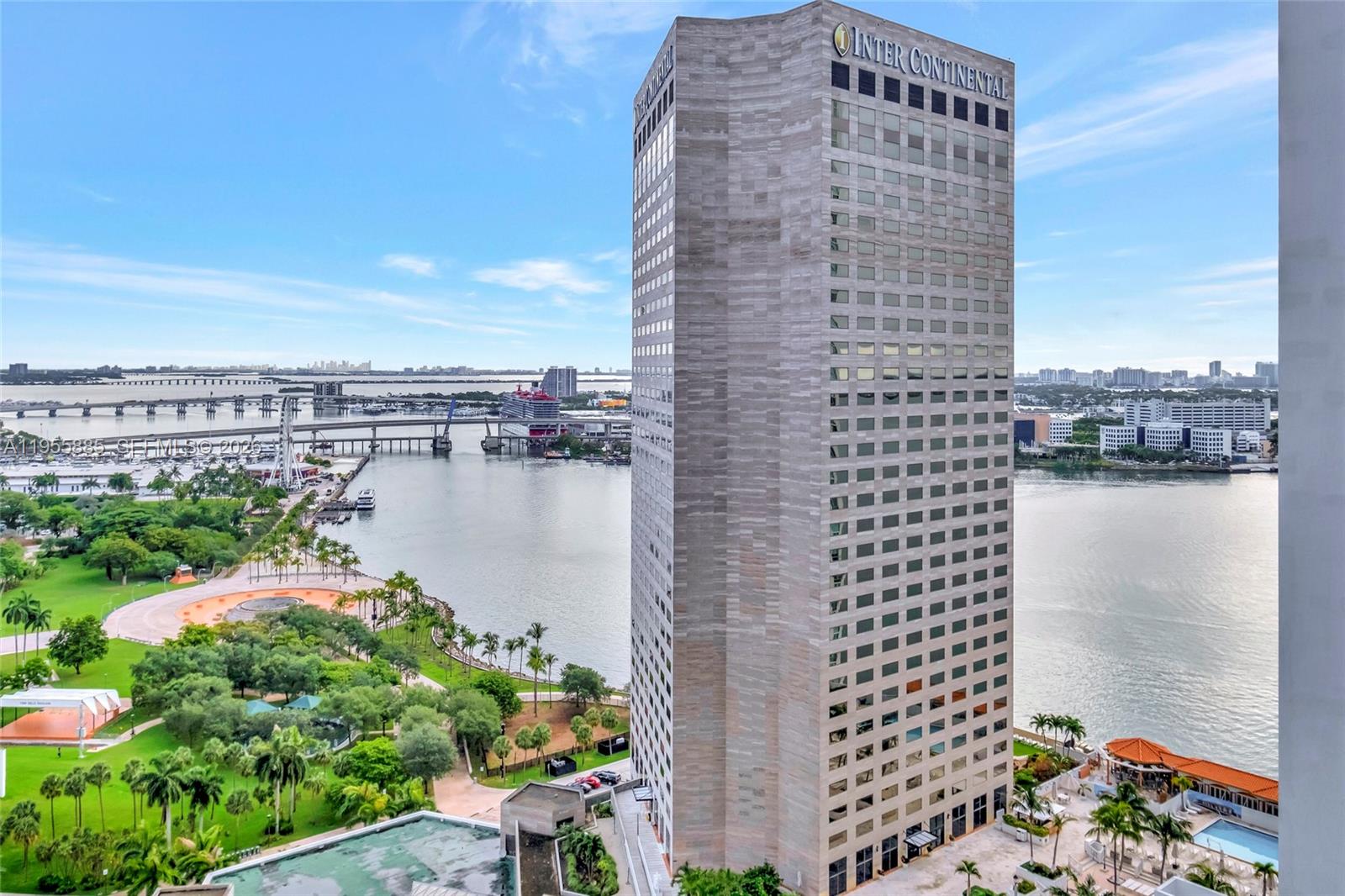 An exterior view of the InterContinental hotel building overlooking a park, water, and bridge — 325 S Biscayne Blvd # 2616, Miami FL 33131, MIAMI, FL