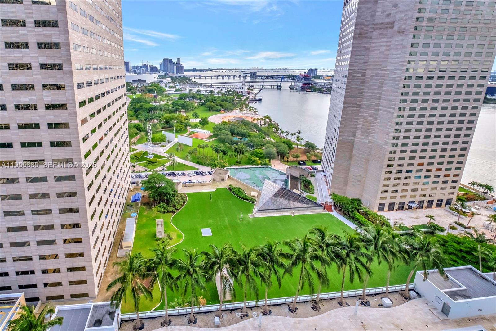 An elevated view shows a green lawn between two tall buildings overlooking a bay — 325 S Biscayne Blvd # 2616, Miami FL 33131, MIAMI, FL