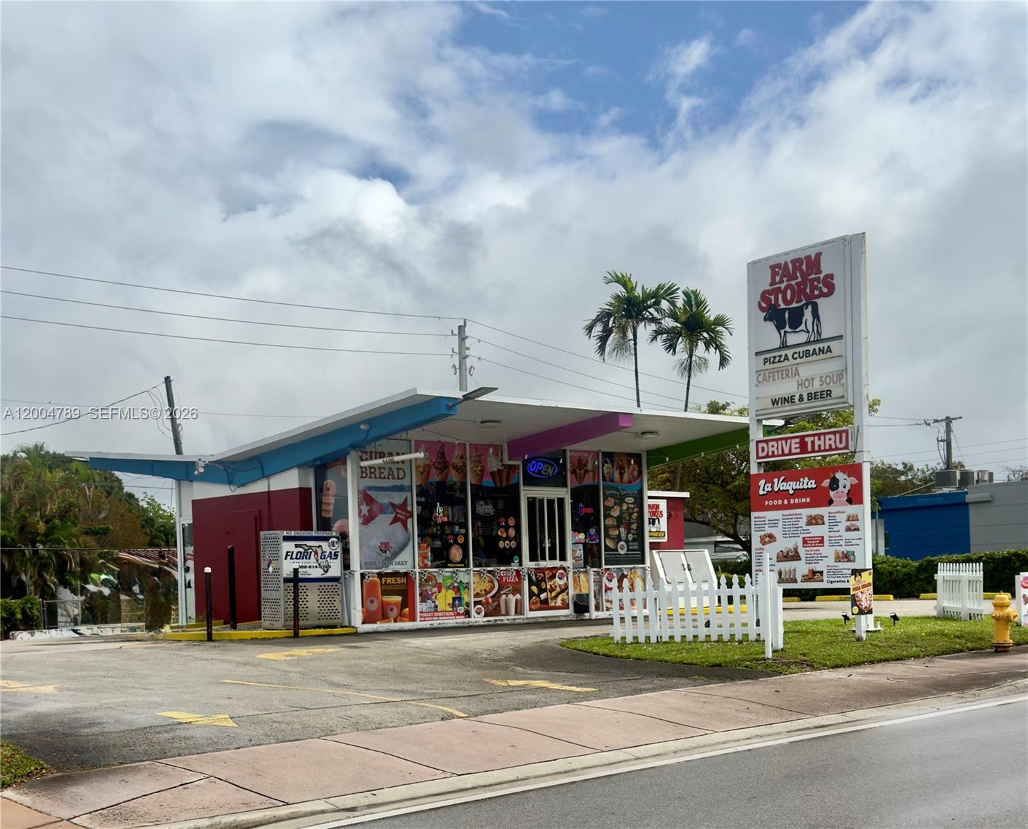 A Farm Stores drive-thru building with a prominent sign stands on a paved lot — FARM STORE CORAL GABLES, Miami FL 33134, MIAMI, FL