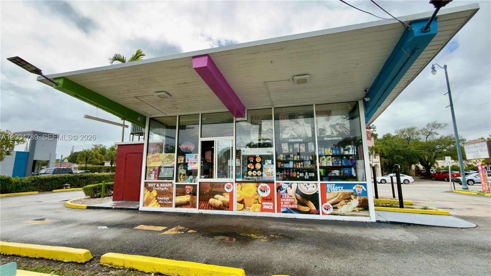 A small, standalone commercial building with a drive-thru canopy and large glass storefront windows — FARM STORE CORAL GABLES, Miami FL 33134, MIAMI, FL