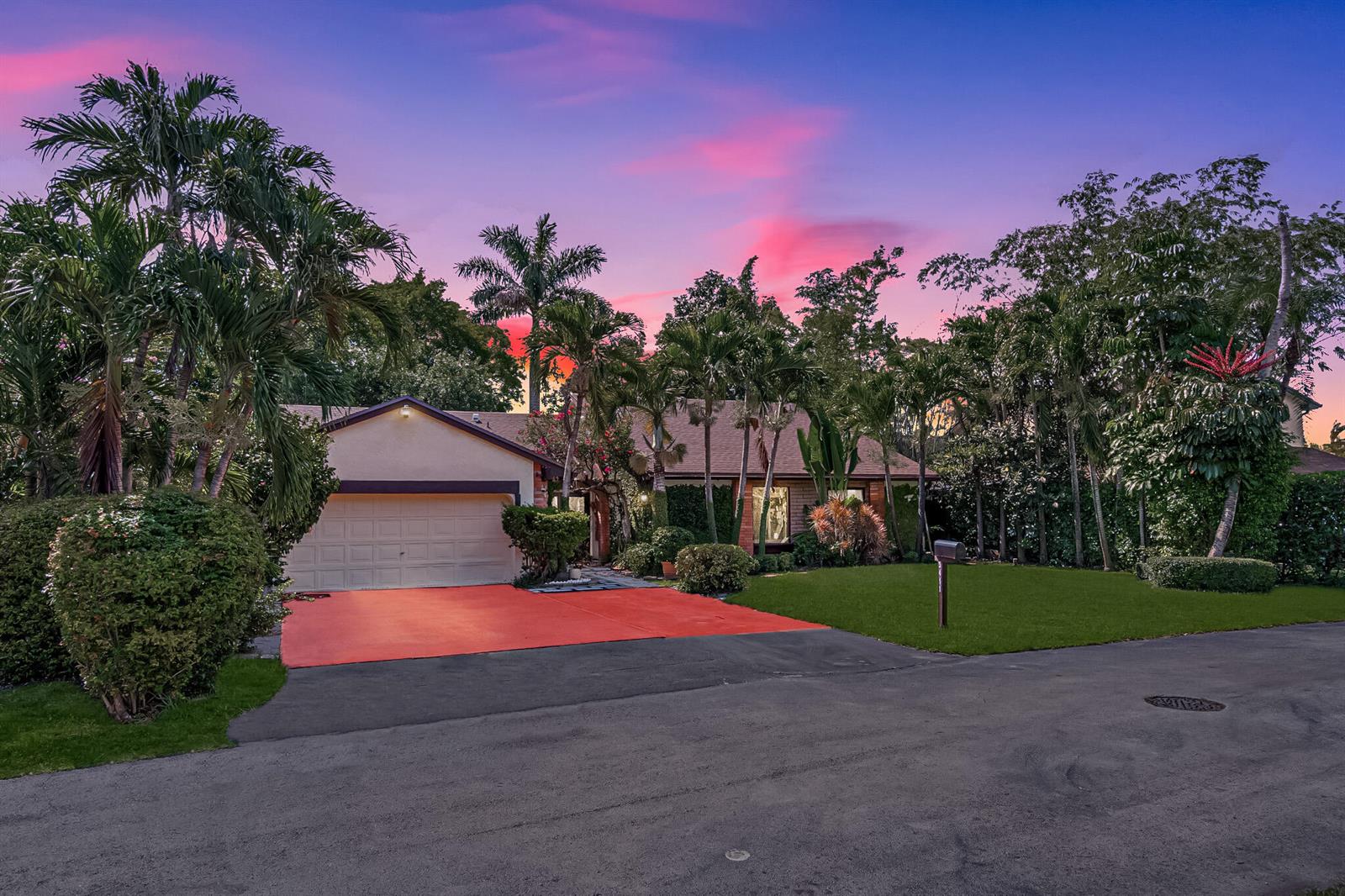 A single-story house with a garage and a bright orange driveway at sunset — 5441 SW 155th Place, Miami FL 33185, MIAMI, FL