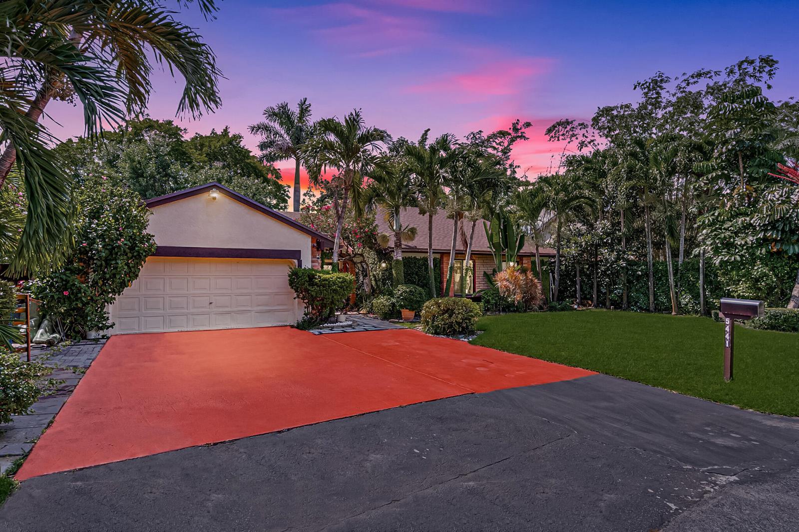 A house with a two-car garage, a red driveway, and palm trees at sunset — 5441 SW 155th Place, Miami FL 33185, MIAMI, FL