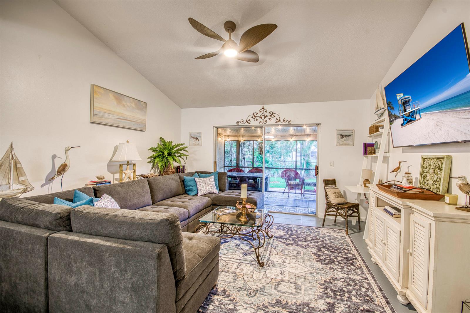 A living room features a gray sectional sofa, a patterned area rug, and a television — 178 Pinewood Court, Jupiter FL 33458, JUPITER, FL
