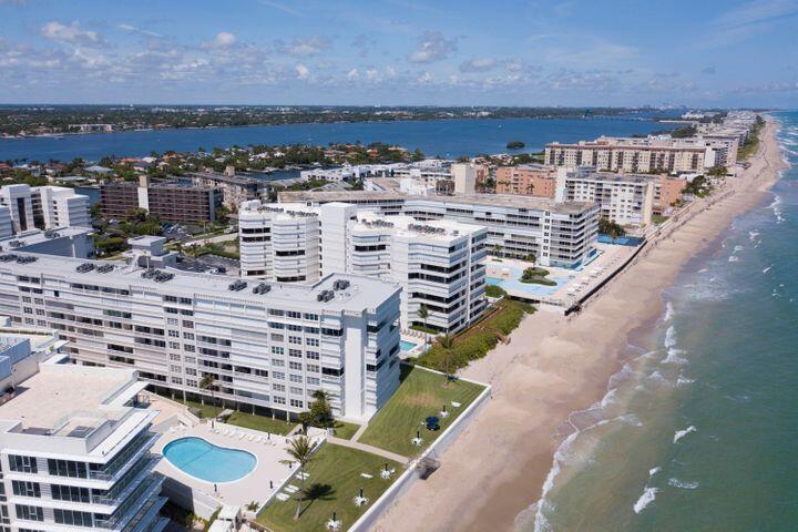 An aerial view of beachfront apartment buildings with swimming pools and a sandy coastline — 3570 S Ocean Boulevard # 806, Palm Beach FL 33480, PALM BEACH, FL