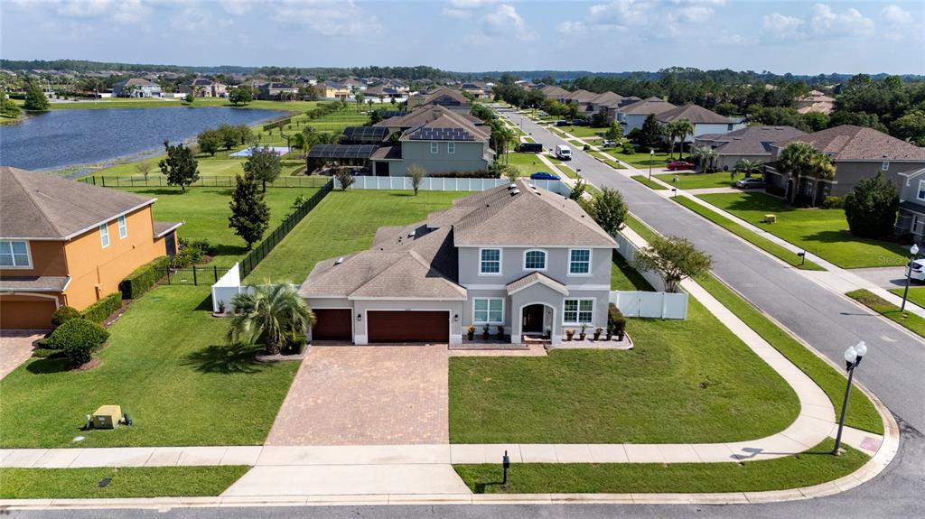 An aerial view shows a two-story suburban house with a paved driveway and large lawn — 14537 SAN LORENZO DRIVE, ORLANDO, FL