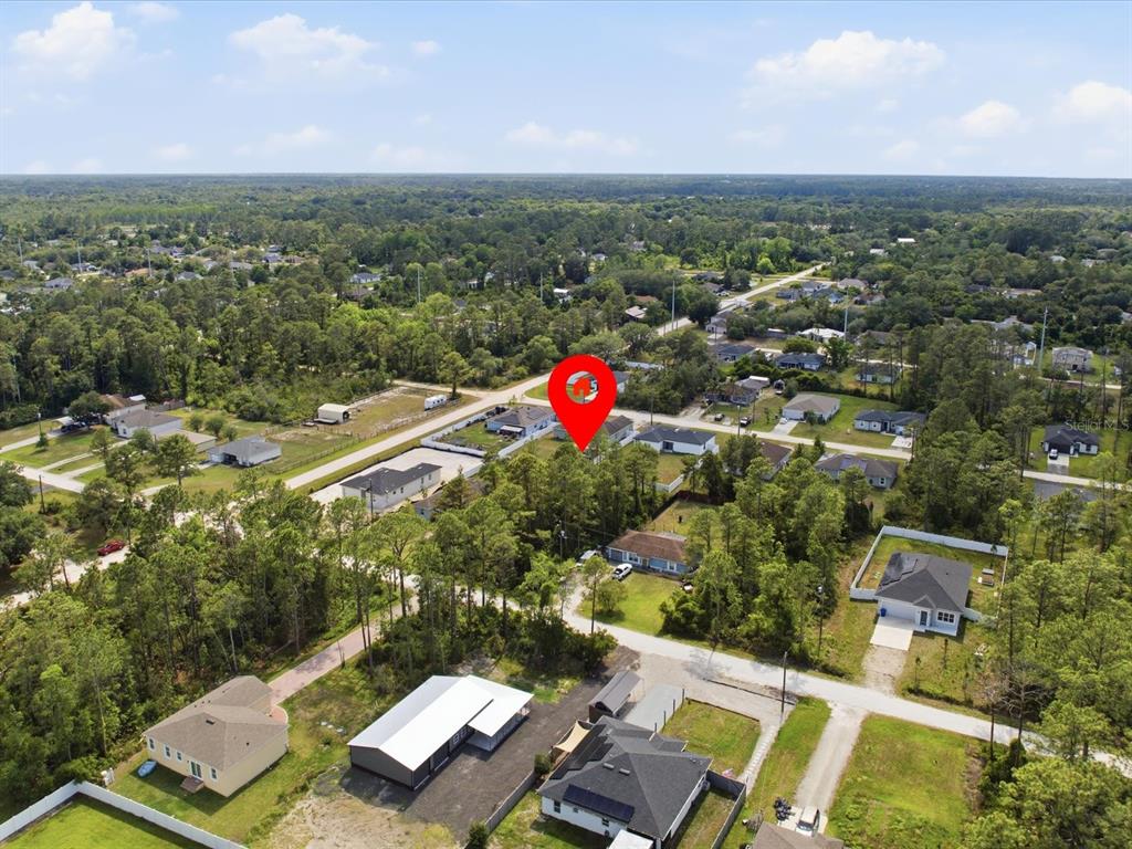 An aerial view shows a wooded residential lot marked with a red location pin — 1340 EAST PARKWAY, DELAND, FL