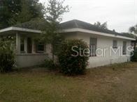 A single-story house with a white exterior, a dark roof, and a small front porch — 2508 50TH AVENUE N, ST PETERSBURG, FL